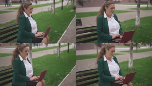 快乐超重的女商人坐在城市的长椅上聊天，在笔记本电脑上上网。肖像自信成功有吸引力的白人妇女在户外短信在线微笑。高清在线视频素材下载