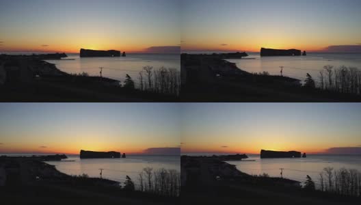 著名的Rocher Perce岩石在加斯比半岛，魁北克省，加斯比西地区与城市景观在多彩的日出，黎明高清在线视频素材下载