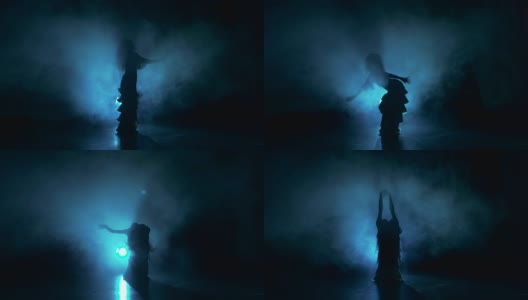 脱衣舞女开始在黑暗中跳舞，阴影，烟雾，剪影高清在线视频素材下载