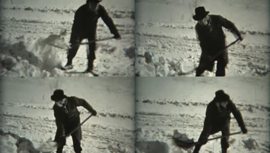 1936年:一名头戴软呢帽、头上裹着围巾的男子在镜头前铲雪。高清在线视频素材下载