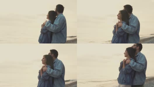 情侣们站在海边，享受着美丽的自然风光高清在线视频素材下载
