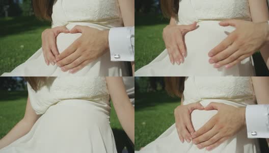 慢镜头:期待一对相爱的年轻夫妇双手合十成心形。高清在线视频素材下载
