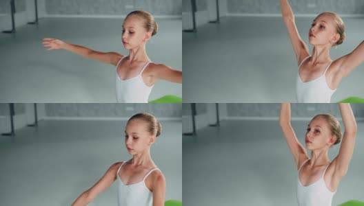 在演播室里，头扎发髻的小芭蕾舞演员举起了双手高清在线视频素材下载