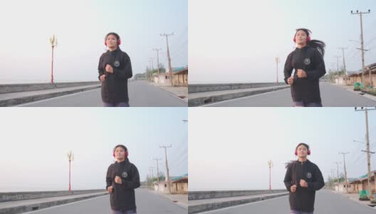 美丽的年轻女子在路上奔跑高清在线视频素材下载