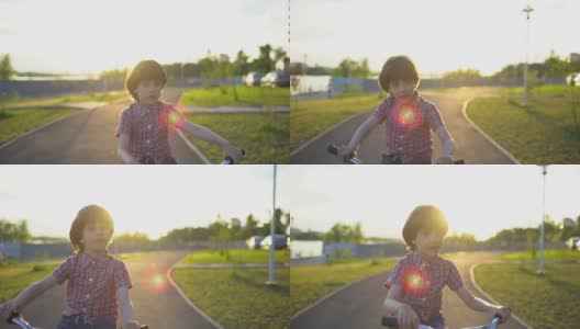 在夏日阳光明媚的夕阳下，一个小男孩在马路上骑自行车。快乐的男孩骑着自行车，在户外享受大自然的乐趣。积极运动快乐家庭休闲度假。慢动作高清在线视频素材下载