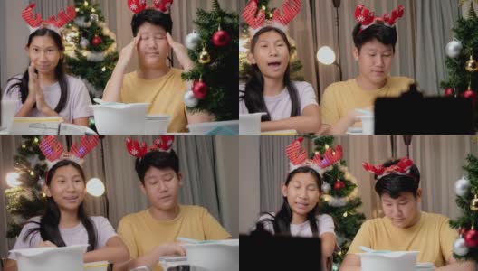圣诞节期间，亚洲孩子们在家里拍摄饼干烹饪视频制作病毒视频，或者在家里一起拍TikTok，这是新一代概念的时尚生活方式。高清在线视频素材下载