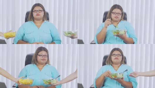 超重的女商人在办公室选择沙拉高清在线视频素材下载