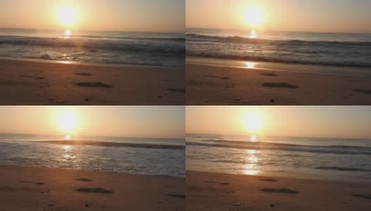 海浪在海滩与天空的橙色光和太阳是在海上股票视频泰国，海滩，日出-黎明，海，日落高清在线视频素材下载