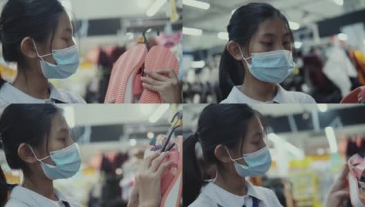 亚洲女学生戴口罩，在超市的零售商店选购商品，新的正常生活理念。高清在线视频素材下载