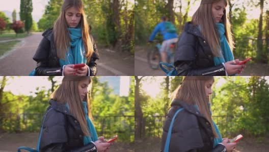 美丽的少女在城市公园发短信高清在线视频素材下载