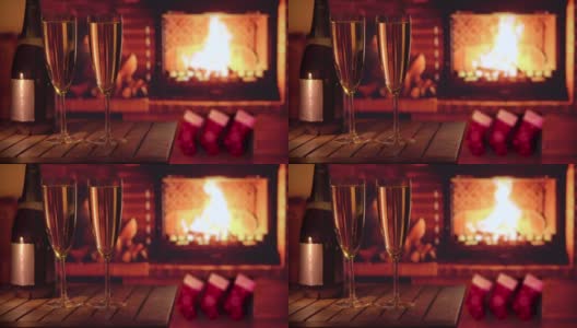 壁炉边放着两个杯子和一瓶香槟。舒适的心情。高清在线视频素材下载