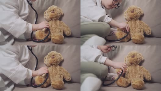 一个女孩扮演医生，用语音内窥镜听玩具熊说话。高清在线视频素材下载
