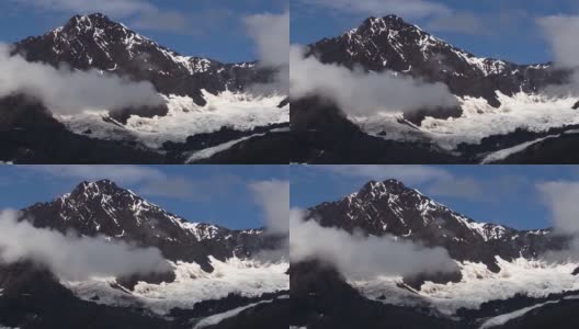 阿拉斯加冰川湾的雪山和冰川周围的小低云。高清在线视频素材下载
