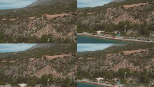 空中-劳特拉基-希腊，垂直向下揭示海岸道路与棕榈树和瀑布高清在线视频素材下载
