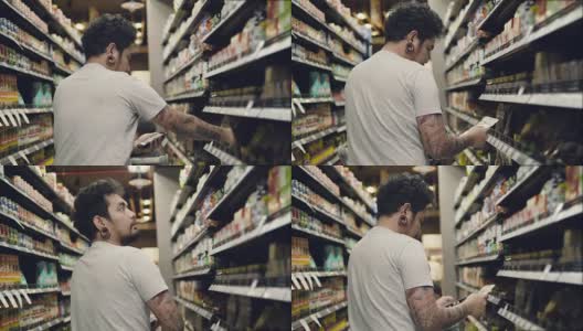 亚洲男子在超市用智能手机买食物。高清在线视频素材下载