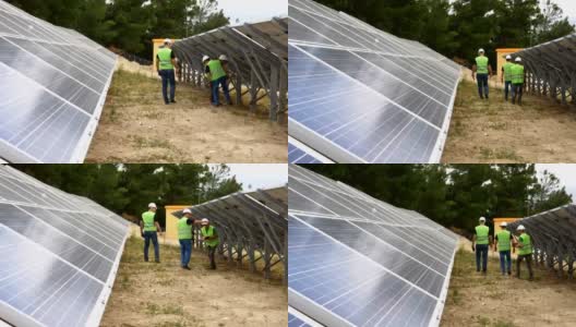 工程师在现场检查太阳能电池板，环保电力生产，可持续可再生能源高清在线视频素材下载