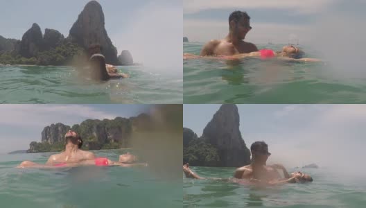 一名男子抱着一名女子在海水里游泳高清在线视频素材下载