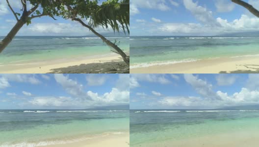 航拍:微风吹在遥远的沙滩上，可以看到清澈的蓝色海洋高清在线视频素材下载