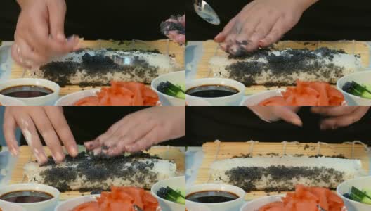 厨师用黑鲟鱼鱼子酱来装饰寿司卷高清在线视频素材下载