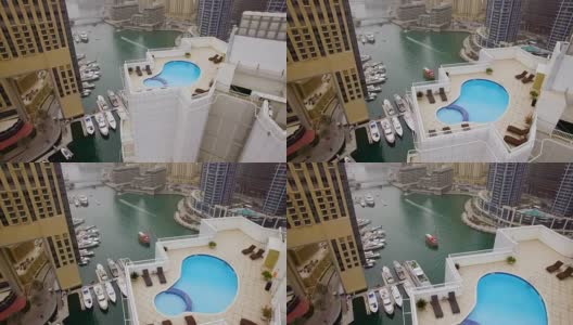在迪拜，阿联酋的摩天大楼的屋顶上水池的鸟瞰图高清在线视频素材下载