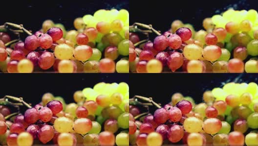 把水洒在多色的葡萄串上。超级慢动作视频高清在线视频素材下载