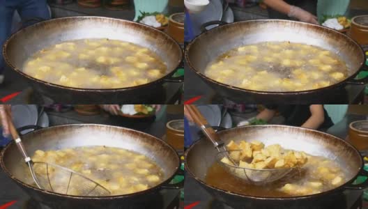油炸豆腐在大锅或炒锅里装满油。越南街头小吃摊，垃圾食品不健康。高清在线视频素材下载