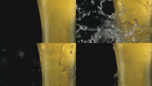 水滴落在装满啤酒的玻璃杯上。新鲜的比喻高清在线视频素材下载