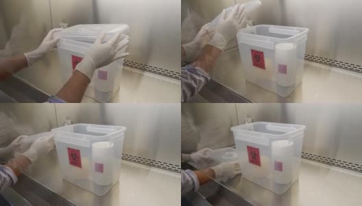 特写镜头，科学家打开微生物实验室里的空生物危害箱，准备放入危险液体和化学品。高清在线视频素材下载