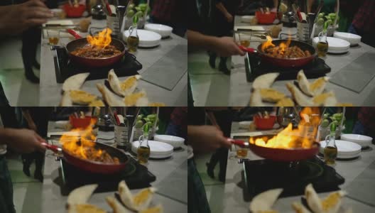 厨师在厨房炉子上用煎锅用火焰烹饪高清在线视频素材下载