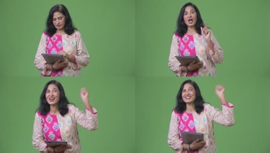 成熟、快乐、美丽的印度女人正在使用数字平板电脑，并获得了好消息高清在线视频素材下载