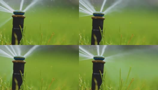 自动洒水系统浇灌草坪在绿色的草的背景高清在线视频素材下载