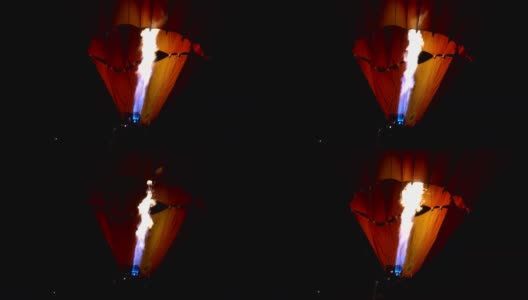 丙烷气体燃烧器在彩色的热气球在夜间飞行在地面上的特写视频高清在线视频素材下载