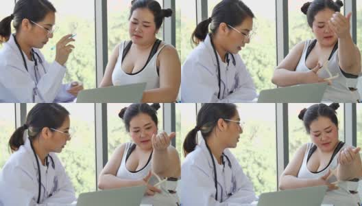亚洲医生用听诊器和测量卡尺测量并建议大块头女性高清在线视频素材下载