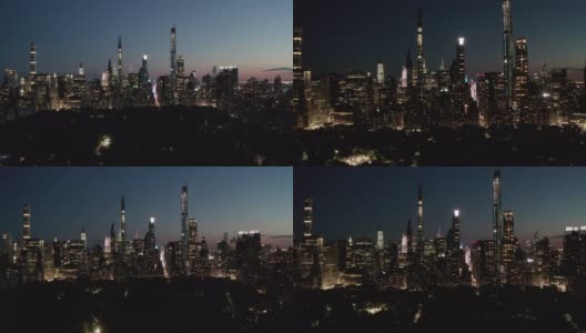 移动时间的推移，在纽约中央公园的夜晚，在曼哈顿摩天大楼的天际线与发光的城市灯光，空中的Hyperlapse高清在线视频素材下载