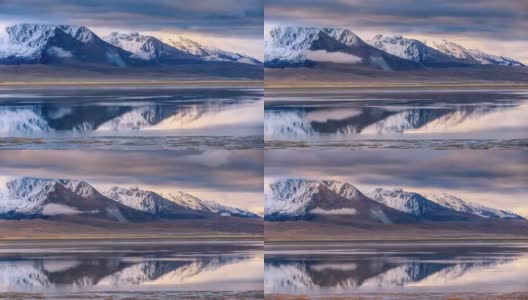 西藏的雪山倒映在湖面上，使湖面变得柔和而美丽高清在线视频素材下载