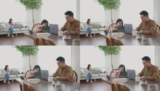 父亲在家工作，女儿在玩平板电脑高清在线视频素材下载