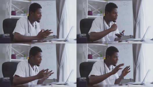 侧面观点自信的非洲裔美国科学家在网上开会，坐在桌子旁，背景是笔记本电脑和白板上的化学公式。严肃的专家化学家说话说服同事。高清在线视频素材下载