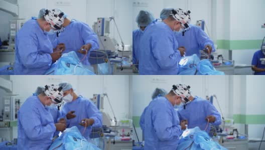 临床外科医生的团队合作。在现代化医院中，一群身着医疗制服的医生使用医疗设备进行手术。高清在线视频素材下载
