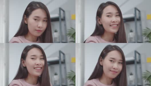 在现代家庭办公室里，美丽的亚洲女商人穿着休闲服装，面带微笑地看着镜头，享受着一个成功的商业项目。高清在线视频素材下载