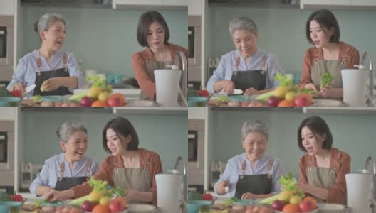 亚洲华人美丽的女人和她的母亲准备做饭为家人在厨房柜台高清在线视频素材下载