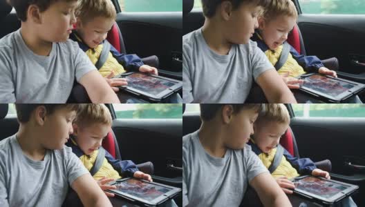 Boys with tablet computer during traveling by car高清在线视频素材下载