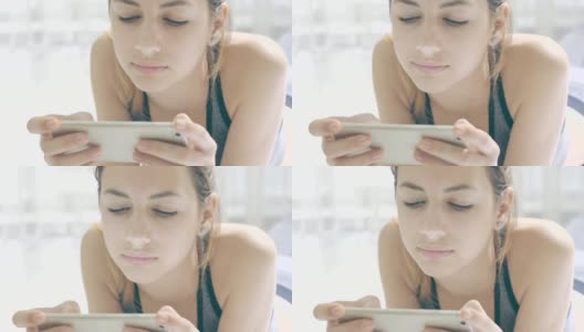 一名年轻女子在健身后使用智能手机上的健身应用程序。高清在线视频素材下载