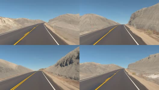 FPV:驾驶沿着空的道路通过灰色的沙漠峡谷在犹他州，美国高清在线视频素材下载