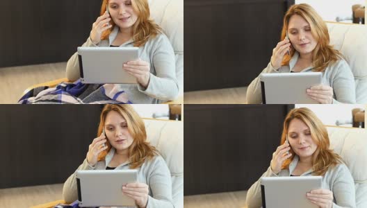 女人坐在沙发上一边用平板电脑一边打手机高清在线视频素材下载