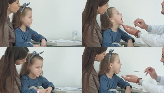 小女孩正在接受男医生用压舌板检查咽喉高清在线视频素材下载