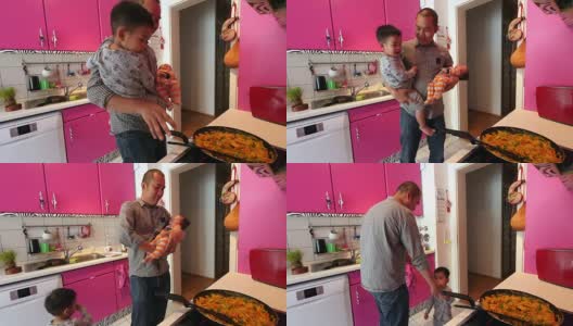 父亲独自在家做饭和照看孩子高清在线视频素材下载