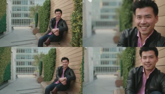 英俊的亚洲男人坐在长凳上高清在线视频素材下载