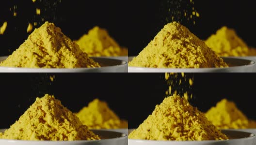 慢动作:黄色姜黄粉倒入一个白色的碗-特写高清在线视频素材下载
