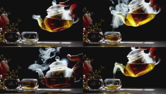 慢镜头，热腾腾的菊花茶从一个玻璃罐里倒进一杯热气腾腾的白烟。高清在线视频素材下载