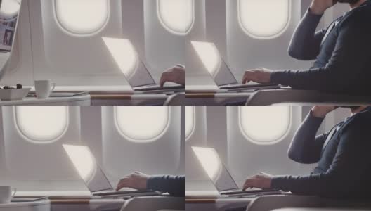 一个在商务飞机上使用笔记本电脑的人高清在线视频素材下载